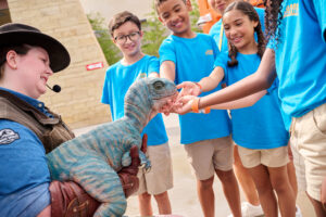Kids meet a newly hatched baby dinosaur.