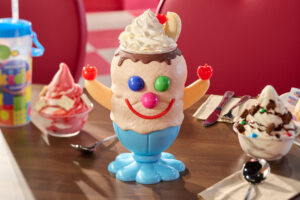 Triple Gooberberry Sunrise features vanilla and chocolate ice cream, strawberry Dole Whip®, chocolate fudge, with crushed s'mores cookie crumbles and strawberry Pop-Tarts® pieces, whipped topping, banana, and a cherry on top.