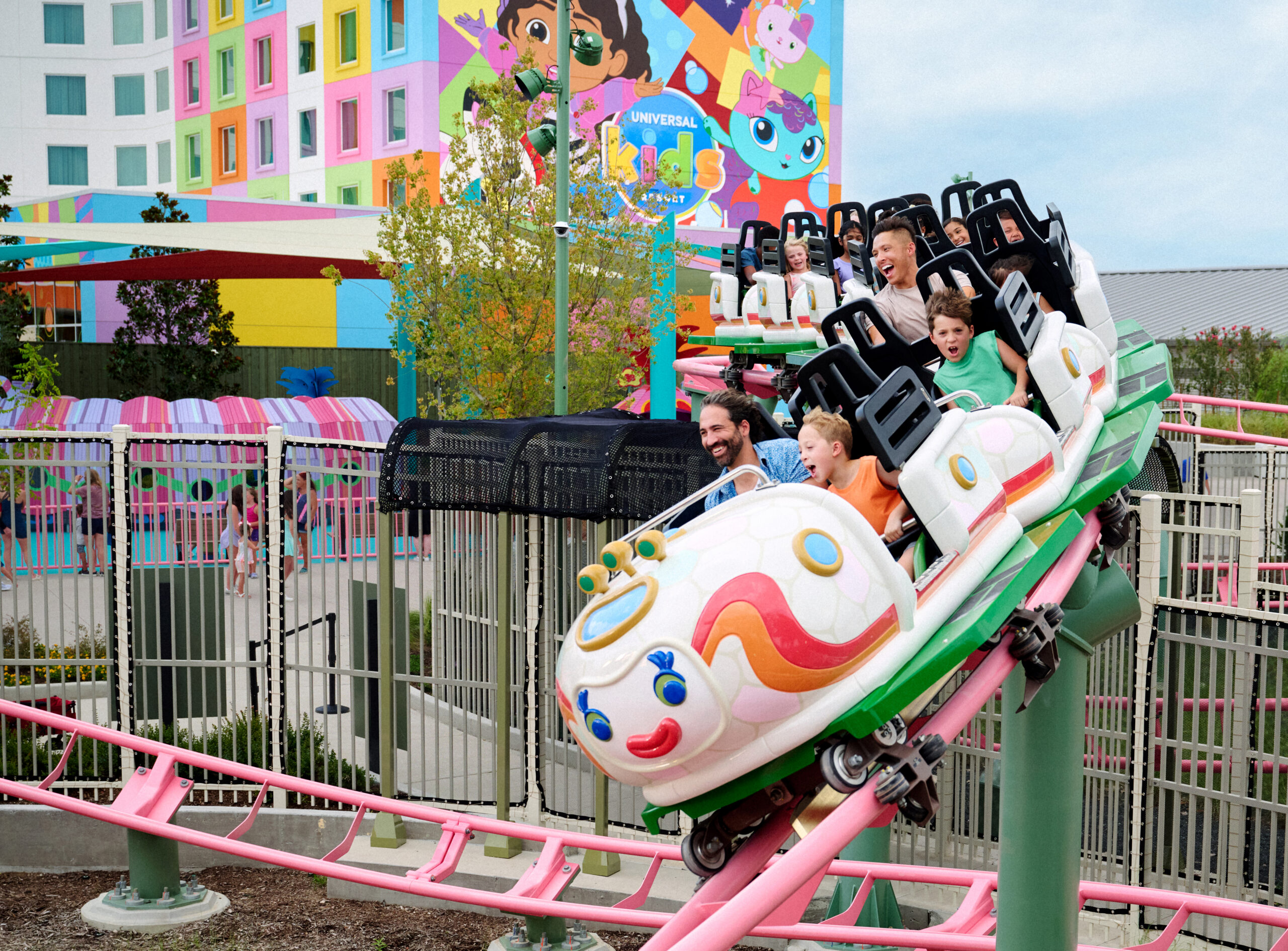 Kids and their grown-ups twist and turn through the festival grounds on an armadillo bus ride on Rhonda’s TrollsFest Express.