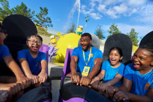 Guests find themselves in the splash zone on the Bello Bay Cruise as they witness the antics between the Yellow Minions and their Purple counterparts.