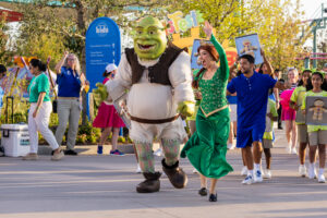 To mark the grand opening of Universal Kids Resort, a playful processional of hundreds of kids, alongside their favorite characters including Shrek and Fiona, paraded to the Isle of Curiosity. 
